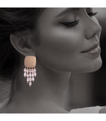 Dangling pearl earrings.
